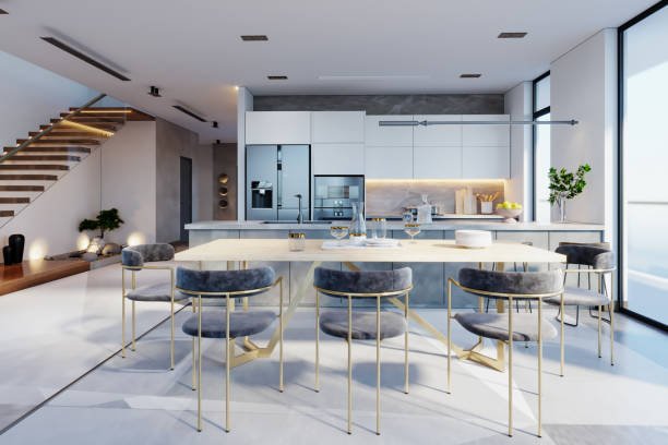 Blogs 6 A modern kitchen and dining area featuring sleek designs and a staircase, showcasing trends for 2025.