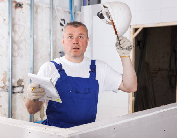 A couple inspects a stylish sink in a bathroom, collaborating on ideas for their remodeling project.
