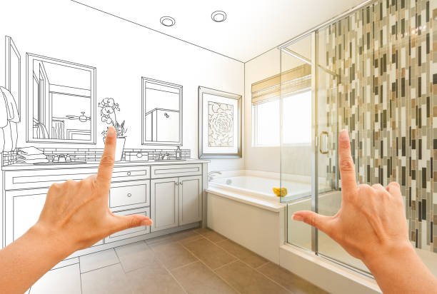 A person holding up their finger in front of a newly remodeled bathroom, showcasing modern fixtures and design.