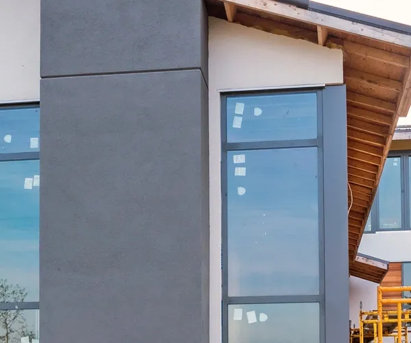 New home addition with grey siding and tall windows, built by NorCal Construction