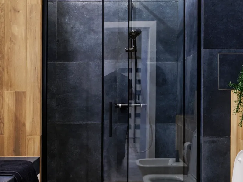 Remodeled walk-in shower with dark stone tile and a glass enclosure, bathroom remodeling in the East Bay