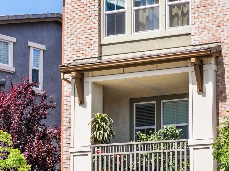 Brick two-storey home with a covered front porch after a whole-home renovation